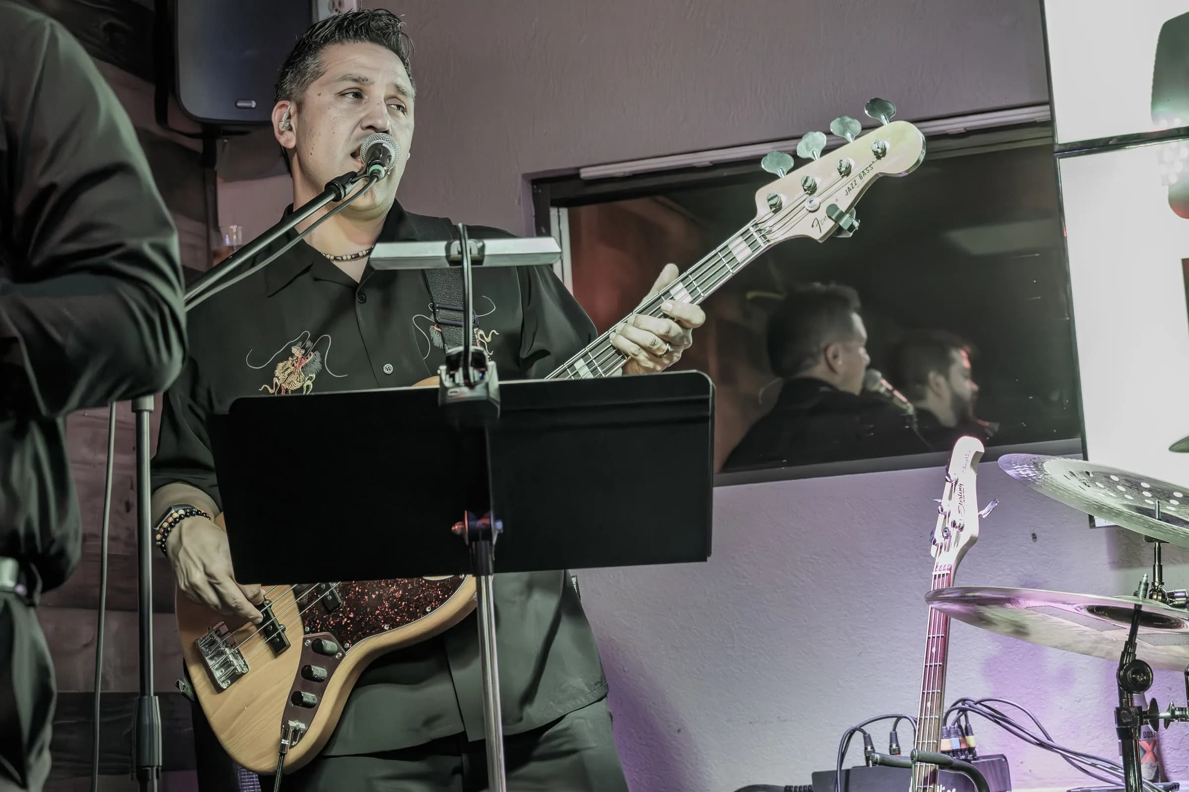 A musician from The Brassanovas playing bass and singing live
