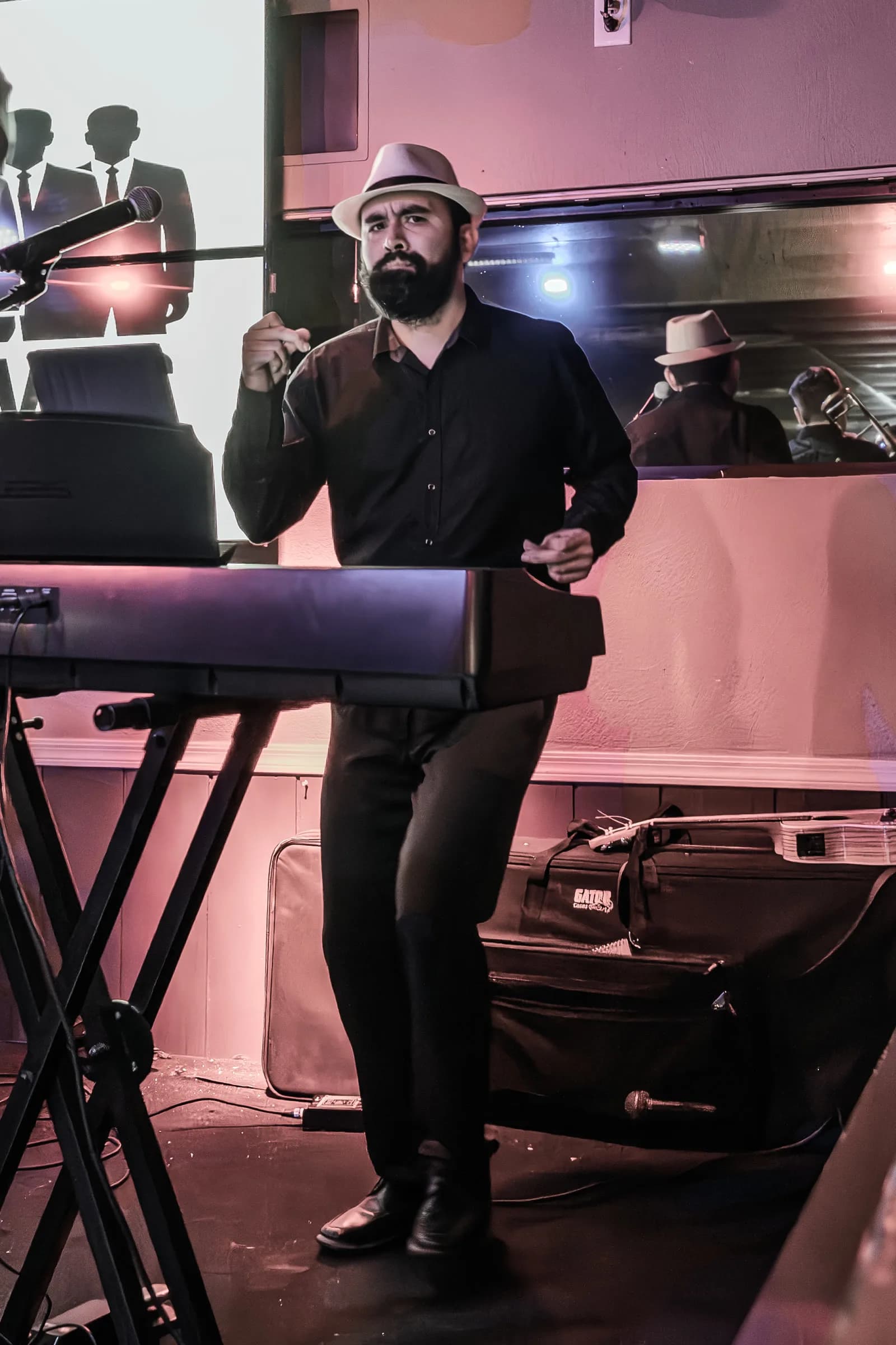 A musician from The Brassanovas performing at the keyboard